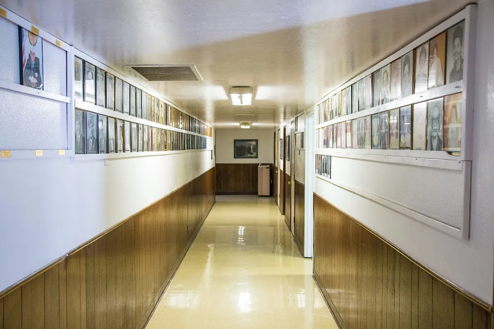 Hallway at Post 26 lined with framed portraits of past members