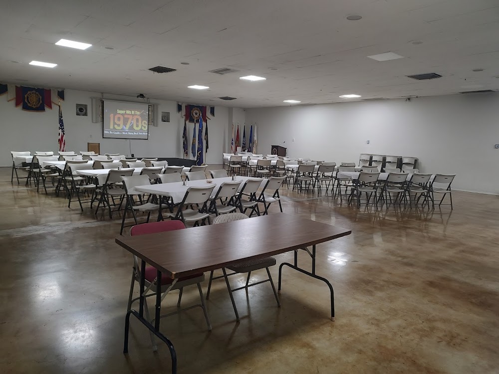 Post 26 event hall set with tables, chairs and a projection screen